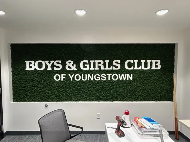 Dimensional letters on a green wall for a youth club