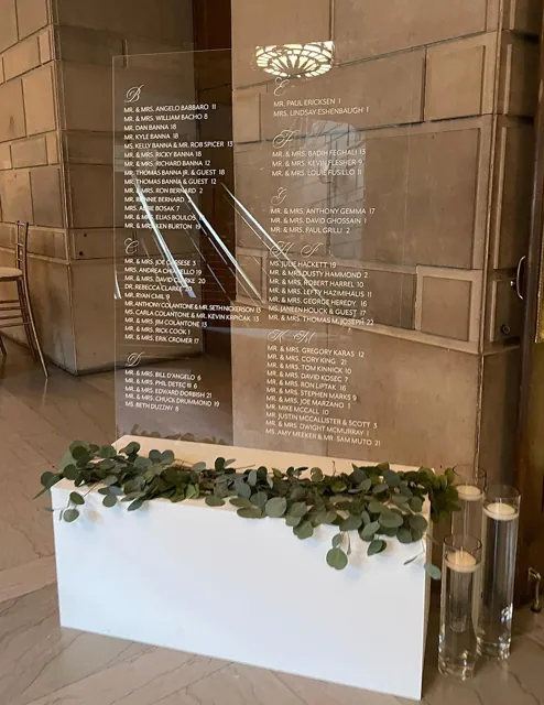 Clear acrylic seating chart with greenery